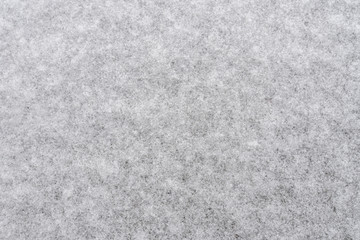 White snow background for designers. White snow closeup snowflakes. Crystals of snow on the ground.