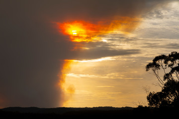 Fototapeta na wymiar Bushfire smoke across a valley in The Blue Mountains at sunset