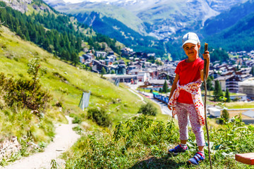 Fototapeta na wymiar funny little happy girl on the mountain top. children outdoors. inspiration