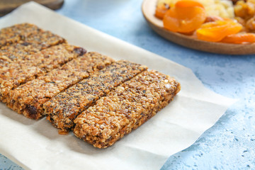 Tasty granola bars on table