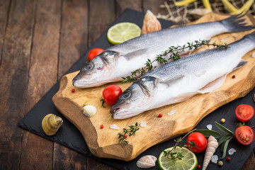 Fresh raw seabass fishon the wooden table