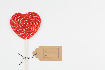 red heart as lollipop candy. Valentines day minimalist background. red heart, love symbol, space for text concept.