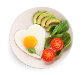 Plate of tasty breakfast with heart shaped fried egg isolated on white, top view
