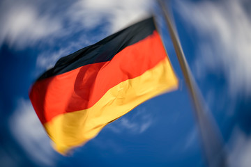 State flag of Federal Republic of Germany against a blue sky. Photo with motion effect.