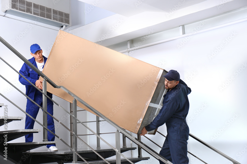 Canvas Prints Professional workers carrying refrigerator on stairs indoors