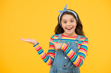 little child yellow background. old fashioned kid fashion. little beauty handkerchief long hair. vintage style. happy childhood. retro girl cheerful gesture. summer vacation joy. presenting product