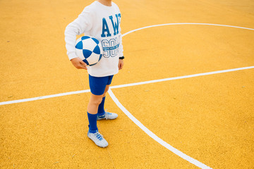 Obraz premium Portrait of soccer player boy with ball in his arm