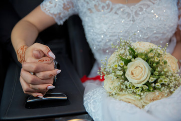 Bride and groom hands with wedding rings and bridal dress . Bride and groom's hands with wedding rings . Wedding couple holding hands .