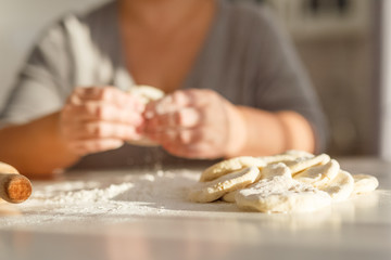 Obraz na płótnie Canvas cooking traditional national dish, yeast dough, flour, women hands