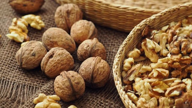 Walnuts on rustic natural burlap, Walnut kernels in wicker basket, Walnut background