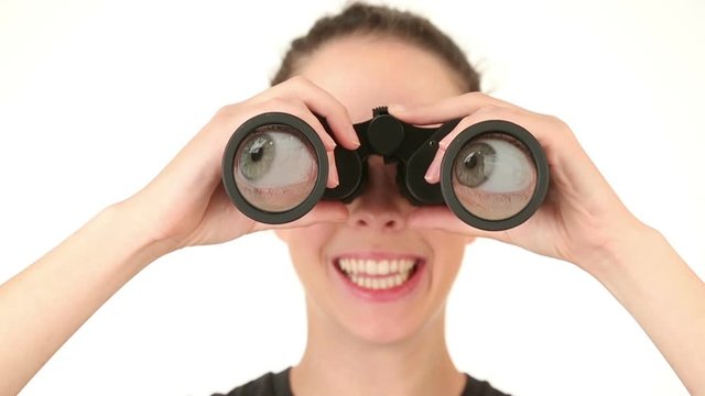Young woman searching with binoculars, rolling eyes around.