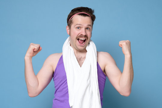 Happy smiling caucasian man with mustache with towel is excited with his results. Going in for sport.