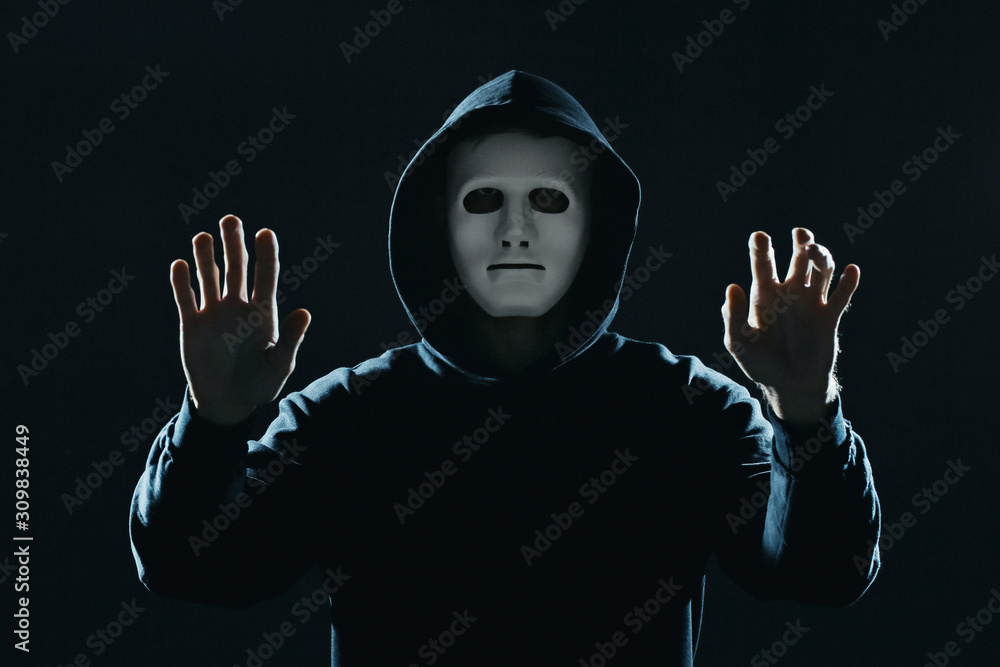 Poster professional hacker in mask on dark background