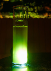 Green cocktails at the bar. Party cocktails and longdrinks with ice garnished with fruits.