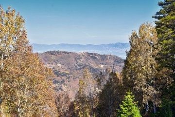 Fototapeta premium Rocky Mountain Wasatch Front peaks, panorama landscape view from Butterfield canyon Oquirrh range by Rio Tinto Bingham Copper Mine, Great Salt Lake Valley in fall. Utah, United States.