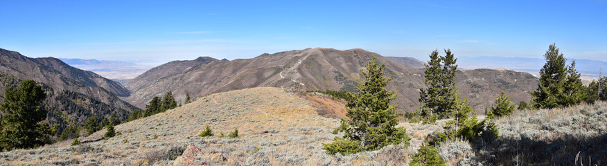 Rocky Mountain Wasatch Front peaks, panorama landscape view from Butterfield canyon Oquirrh range by Rio Tinto Bingham Copper Mine, Great Salt Lake Valley in fall. Utah, United States.