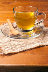 Green tea on a glass cup on wooden table