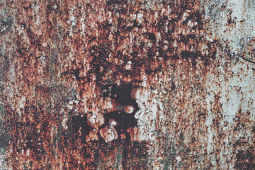 Rusty metal grunge texture background. Old worn iron plate with peeled off paint and scratches. Toned, close up, copy space
