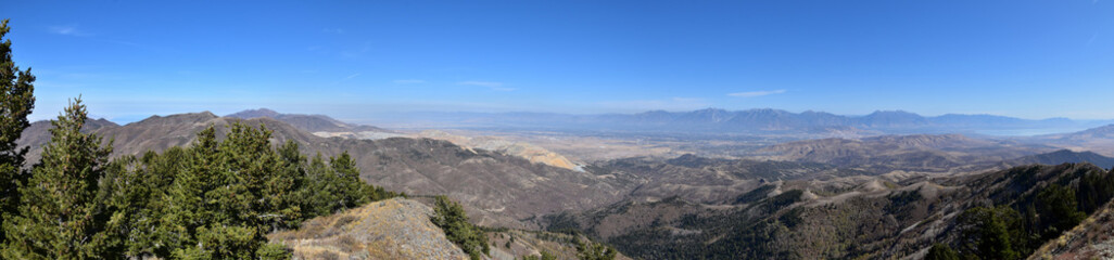Rocky Mountain Wasatch Front peaks, panorama landscape view from Butterfield canyon Oquirrh range by Rio Tinto Bingham Copper Mine, Great Salt Lake Valley in fall. Utah, United States.