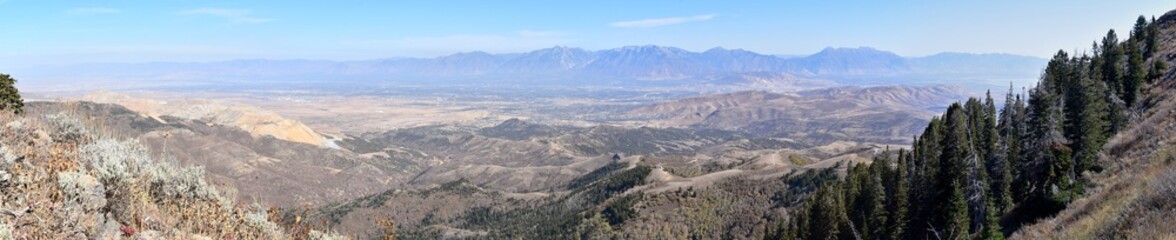Rocky Mountain Wasatch Front peaks, panorama landscape view from Butterfield canyon Oquirrh range by Rio Tinto Bingham Copper Mine, Great Salt Lake Valley in fall. Utah, United States.