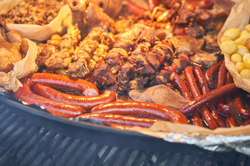 Preparation of meat and national dishes over an open fire, as well as hot wine, mulled wine. Christmas market on Dome Square, in the Old Town.