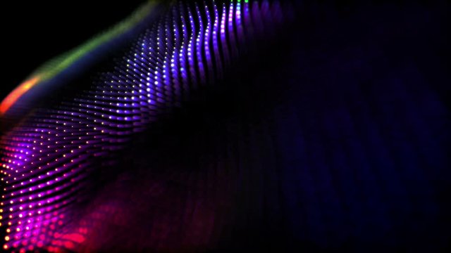 round particles with neon glow move slowly on a black background. Abstract animated background. 3d render
