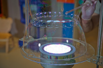 Children's party. To burst the soap bubble . Soap bubbles show.