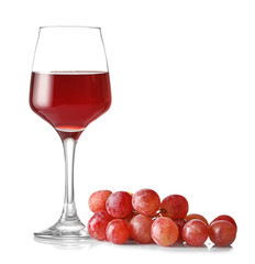Glass of wine and grapes on white background