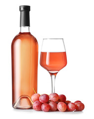 Obraz premium Elegant rose wine bottle and glass with fresh red grapes, refreshing summer drink and vineyard product