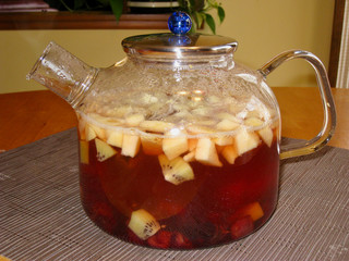 Glass teapot with fresh fruit tea brewing inside
