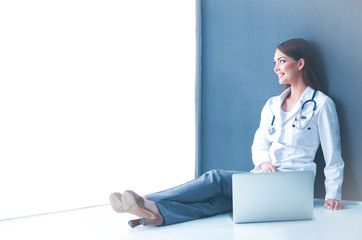 Female doctor using tablet computer in hospital lobby