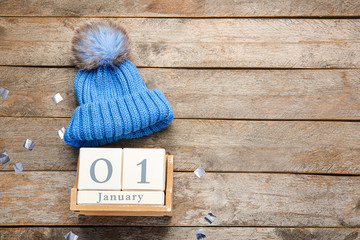 Calendar with date of New Year on wooden background