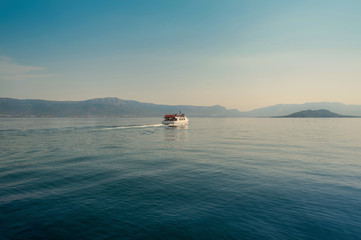 Little ferry, water bus with tourists on board heading from Trogir to Split town in Croatia. Europe.