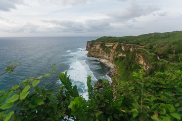 Fototapeta na wymiar The rocky coast of the island of Bali. Wave, the ocean, evening, clouds.