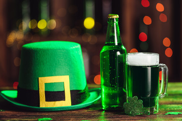Green beer and Leprechaun's hat on table. St. Patrick's Day celebration