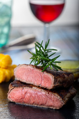 slices of grilled steak on black slate