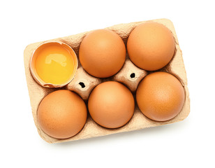 Package with fresh eggs on white background