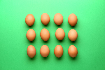 Fresh eggs on color background