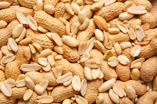 Heap of tasty peanuts, top view