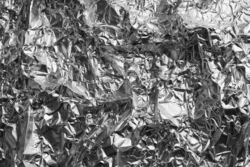 Crumpled silver foil as background, closeup view