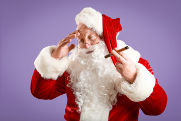 Funny drunk Santa Claus with cigar on color background