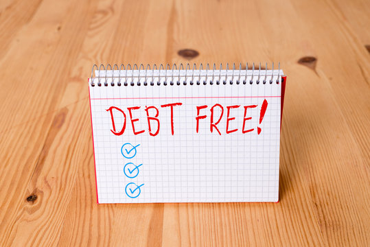 Handwriting text writing Debt Free. Conceptual photo does not owning any money or things to any individual or companies Empty reminder wooden floor background spiral notebook groove slot office