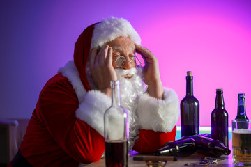 Funny drunk Santa Claus in pub