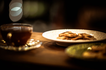 Tea cups with thin cream wafers. Teas with hot smoke. Fine cookies with accompanying special teas.