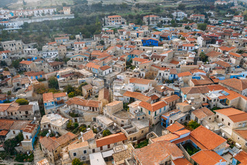 Aerial view of traditional mountain Cyprus village Pano Lefkara with red and orange roofs of buildings, drone photo.