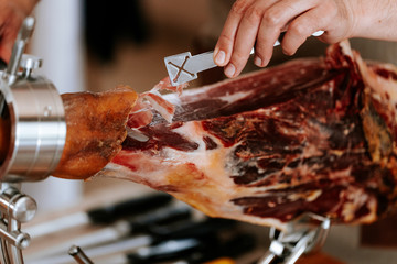 Chef cut a slice of traditional spanish jamon