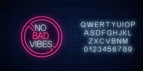 No bad vibes - glowing neon phrase in red warning circle with alphabet. Motivation quote in neon style.