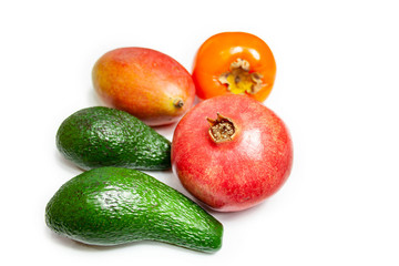 Avocado, pomegranate, persimmon and mango fruit on a white background