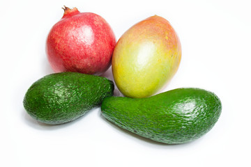 Avocado, pomegranate and mango fruit on a white background