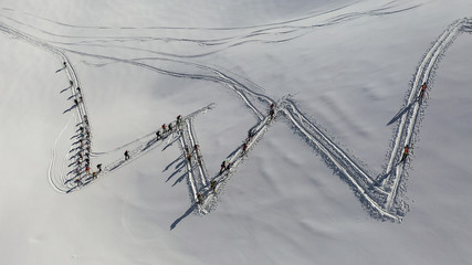 4k aerial photo with ski mountaineers competing during a ski touring race